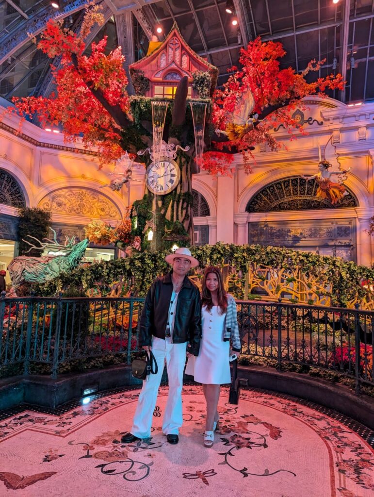 couple at bellagio conservatory & botanical gardens fall theme the garden of time