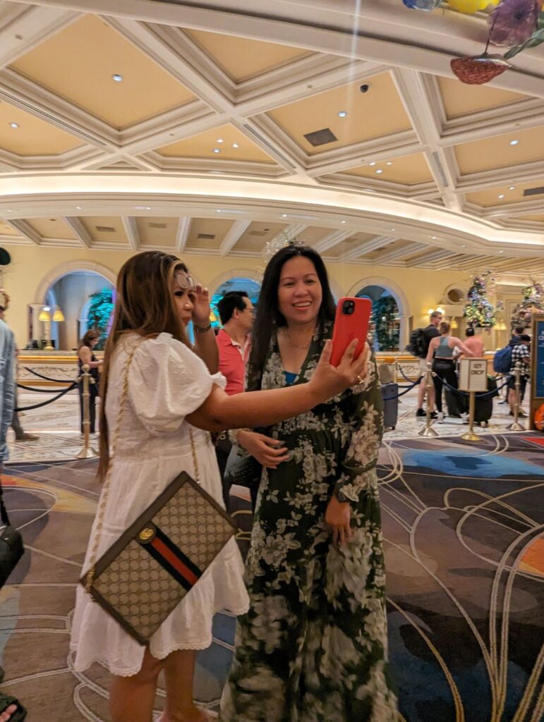 girls taking photos at bellagio hotel lobby